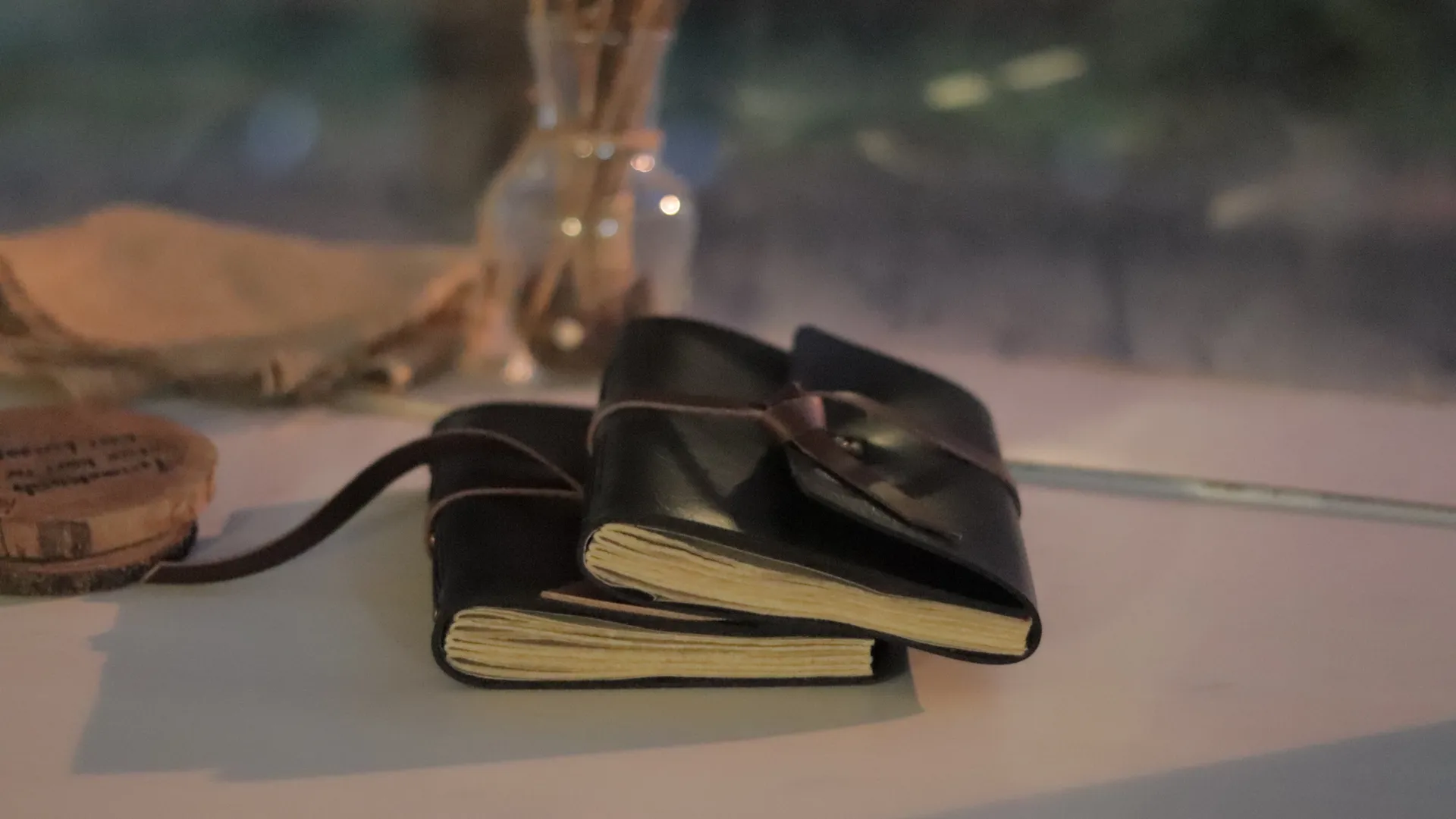 Two Black Leather Notebooks On Table