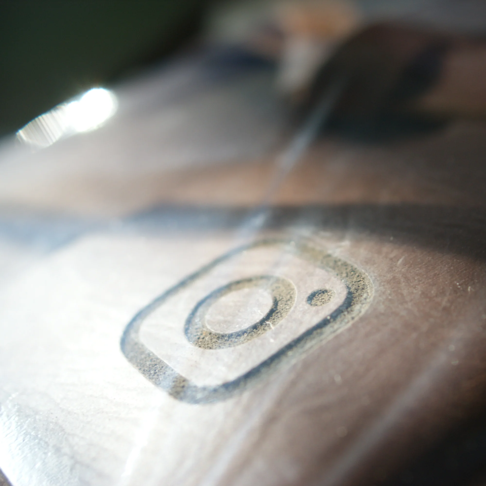 An Instagram logo debossed onto a brown leather surface.