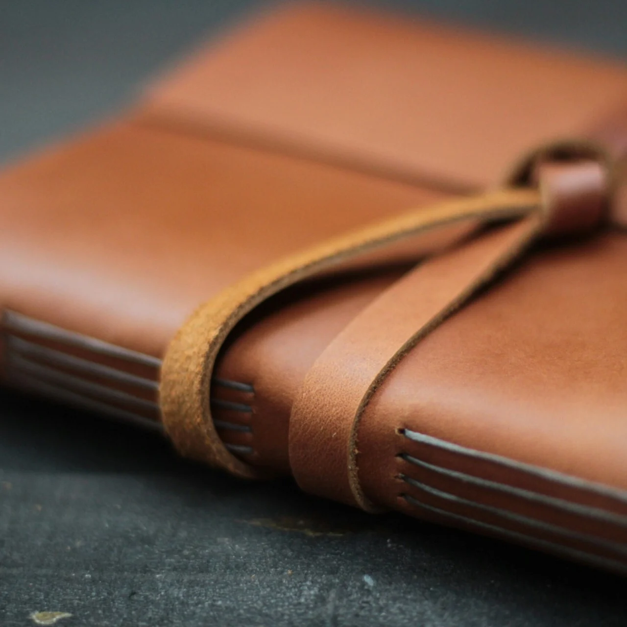 Brown leather journal with a wrap-around strap for the BPJS Kesehatan project.