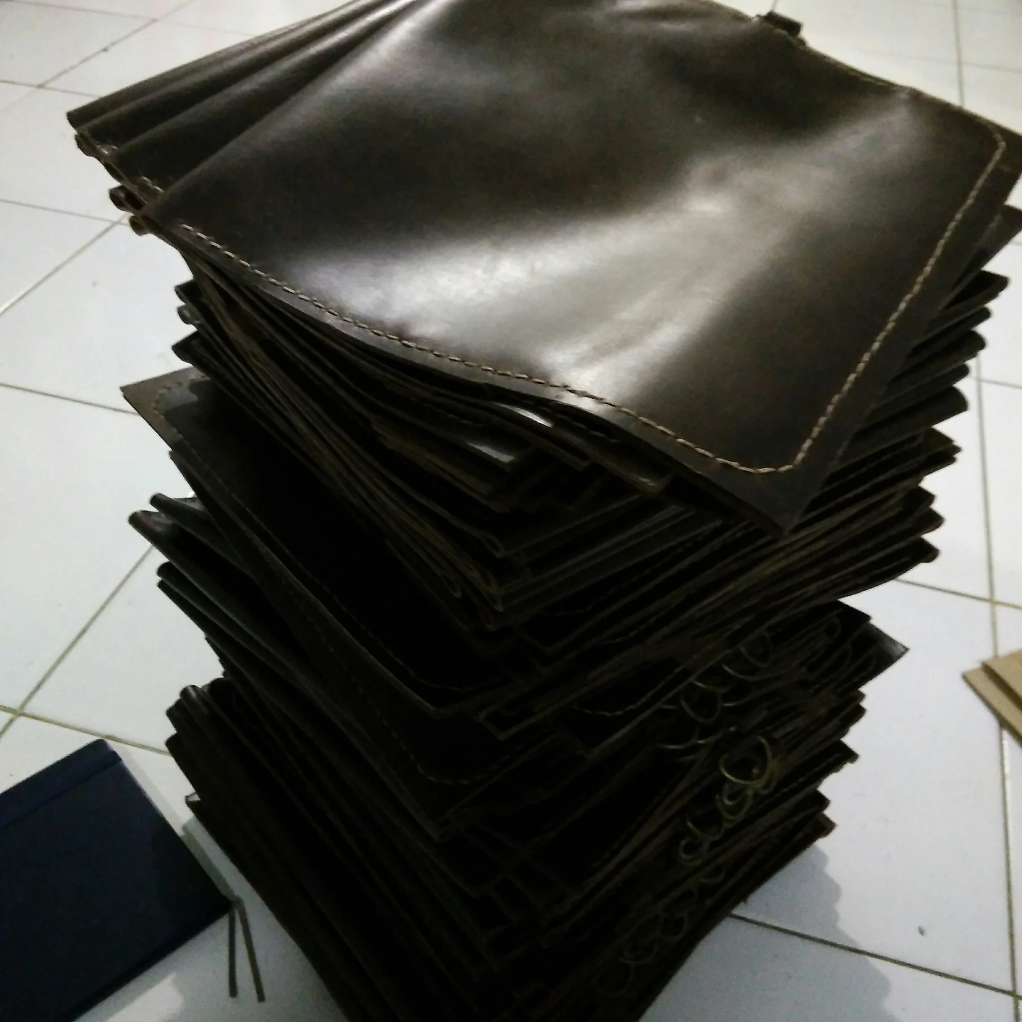 A stack of dark leather pouches for the Pemprov Riau project.