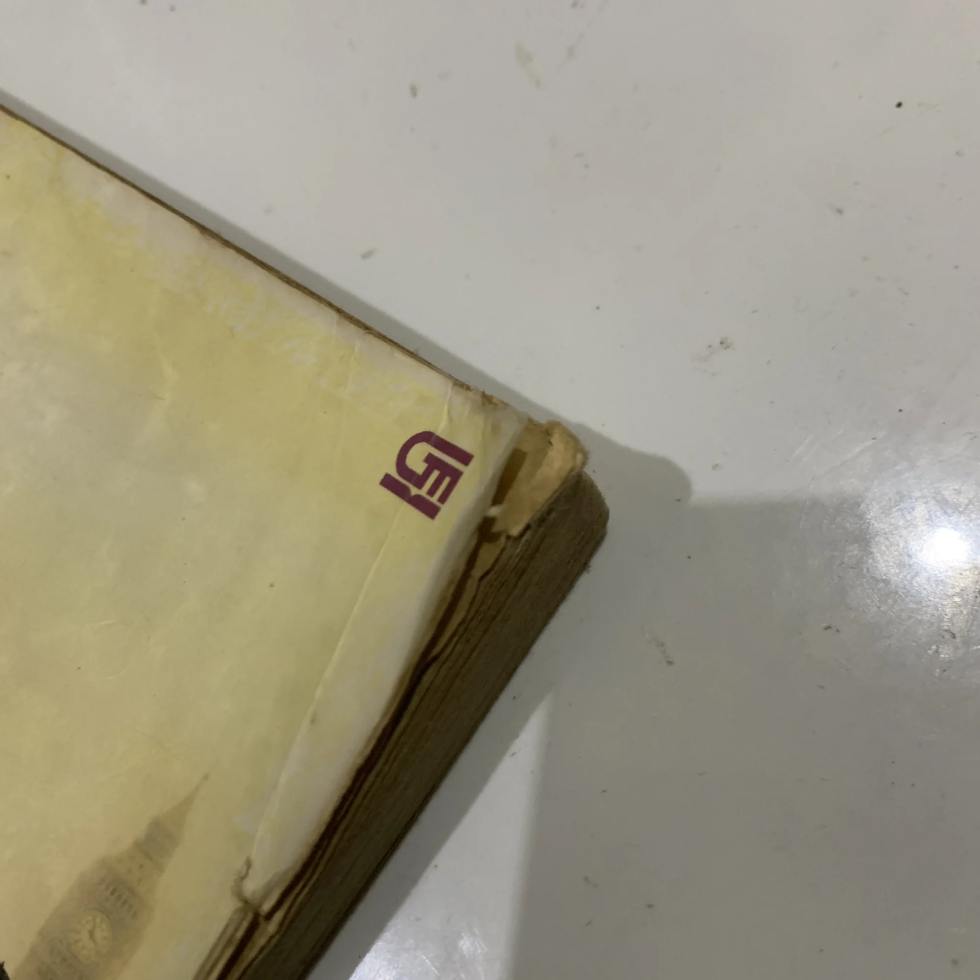 A corner of a novel cover showing a dog-ear fold.