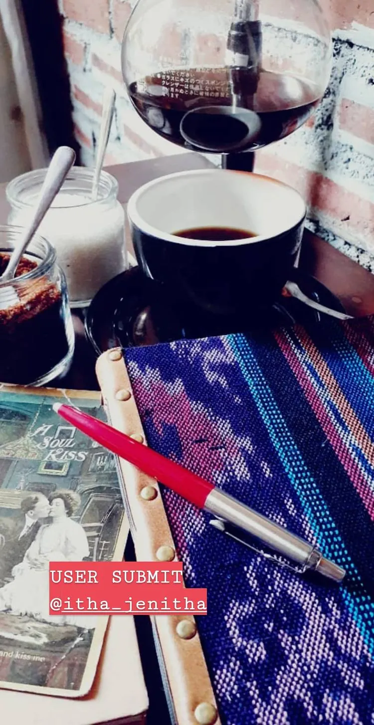Story Instagram dari @itha_jenitha: jurnal bersampul kain tenun ungu dengan pena merah, secangkir kopi dan segelas anggur merah
